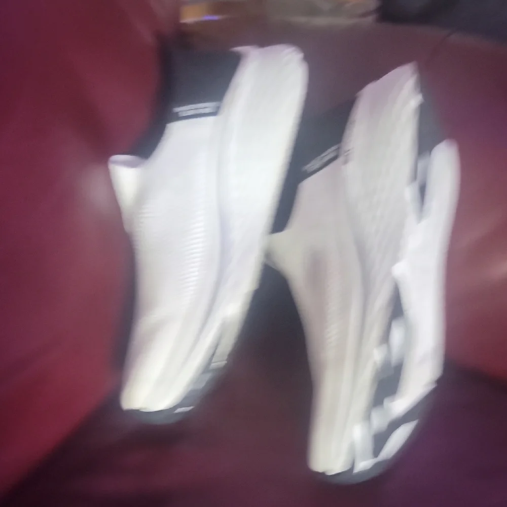 Skechers White and Black Max Cushion Slip-Ons